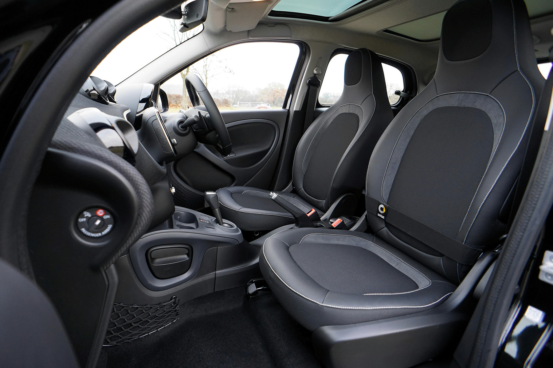 the clean interior of a car with black leather seats